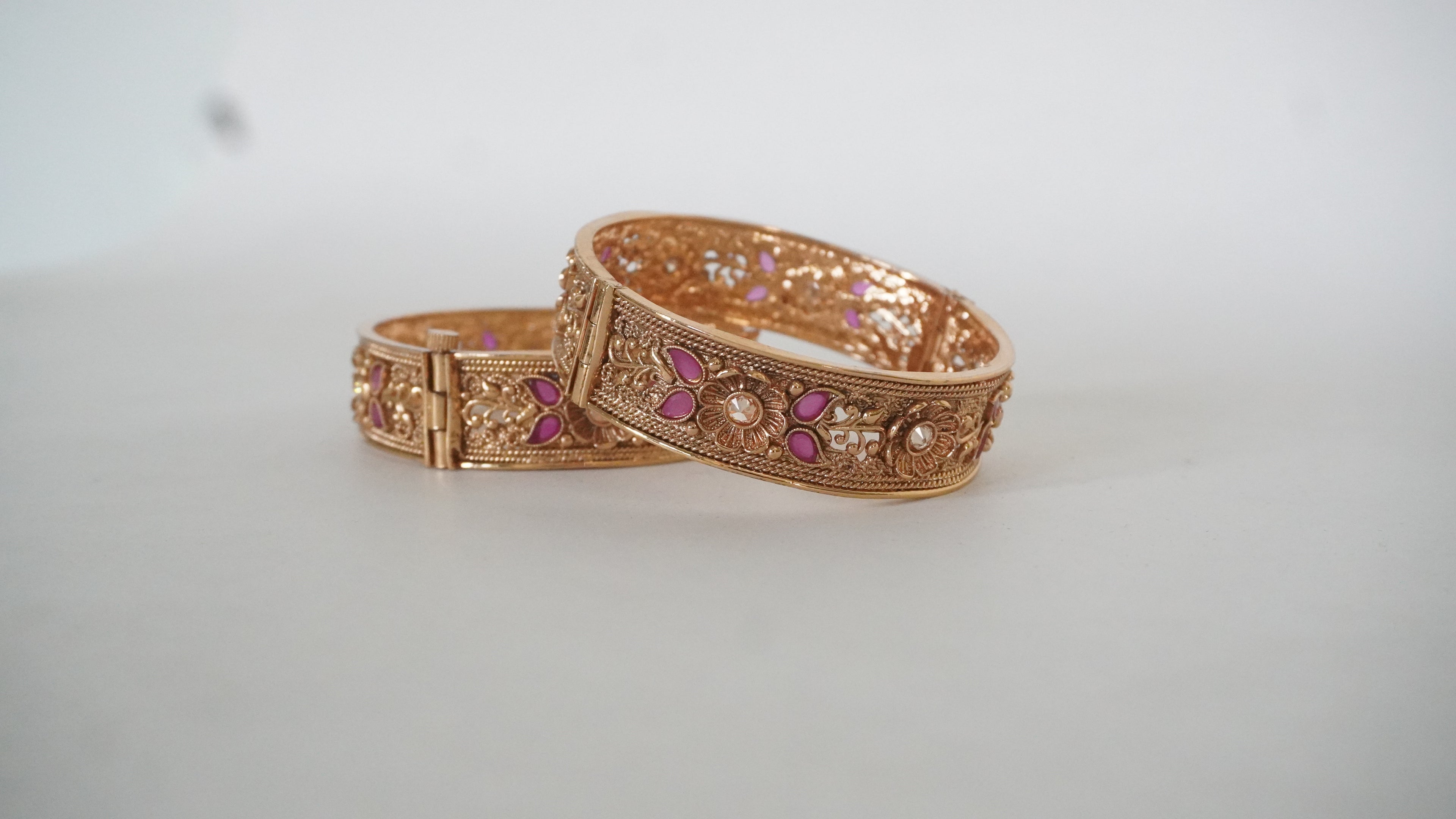 Elegant Gold-Toned Floral Kada Bangles with Vibrant Pink Accents and Intricate Filigree Work