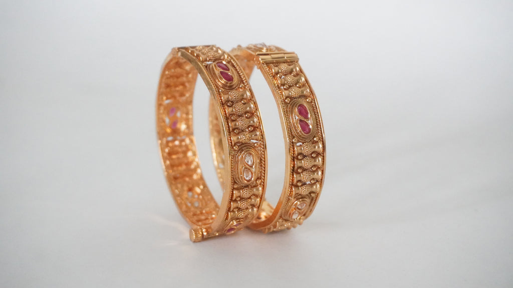 Traditional Gold-Toned Textured Kada Bangles with Vibrant Pink Gemstones and Secure Screw-Pin Closure