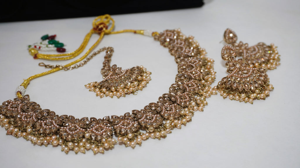 Antique Gold-Toned Floral Choker Set with Champagne Stone Accents, Matching Earrings, and Maang Tikka