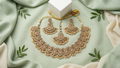 Antique Gold-Toned Floral Choker Set with Champagne Stone Accents, Matching Earrings, and Maang Tikka